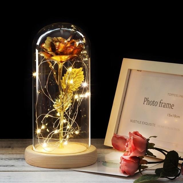 Rose in a glass dome on a wooden base. - Adilsons